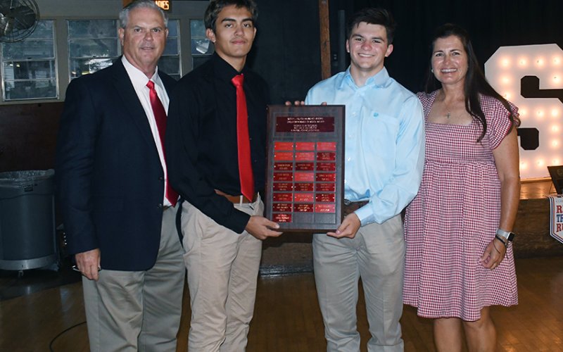 Michael Muelker Memorial Scholarship winners Ezekiel Rodriguez (second from left) and Gus Collins (second from right) . Also shown are Barry Wolf (left, athletic director) and Nicco Brown (right). Photo by Mark Lube.