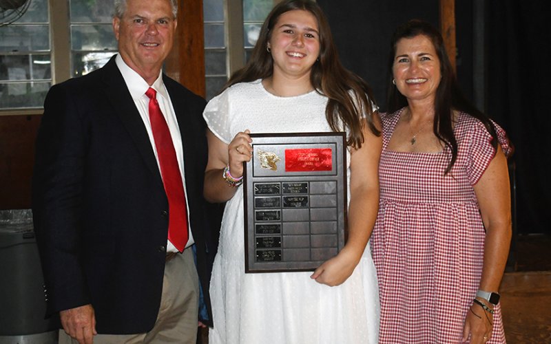 Lady Cardinals Impact Award winner Mary Sue Filip (center). Also shown are  Barry Wolf (left, athletic director) and Nicco Brown (right). Photo by Mark Lube.