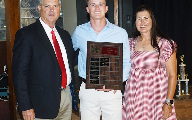 Cardinals Impact Award winner Blaine Humes (center). Also shown are Barry Wolf (left, athletic director) and Nicco Brown (right). Photo by Mark Lube.
