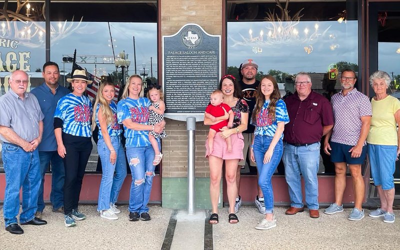 Palace Saloon and Cafe: left to right, Doug Kubicek, LCHC Chair, Mario Gamez, Meredith Reinhardt, Kelsie Herman, Kristal Vega holding Klaira Herman, Brittney Boothe holding Ricky Boothe, Frank Vega, Kaelie Vega, Duff Wagner, Kenneth Stock and Gussie Kelnar.