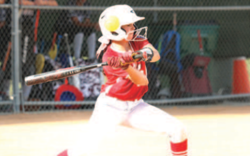 Photo by Chuck Grafe Quinn Henneke chokes up as she waits for the pitch Sunday.