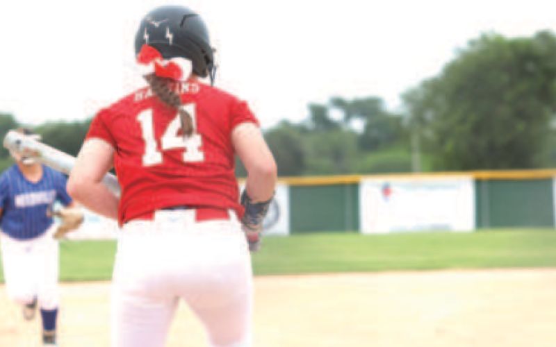 Photo by Chuck Grafe Piper Hawkins attempts to lay down a bunt in the Needville game July 1.