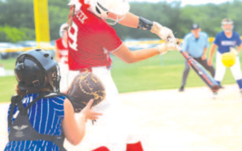 Photo by Chuck Grafe Brenna Bucek hits an 0-2 pitch for a run-scoring double vs. Needville.