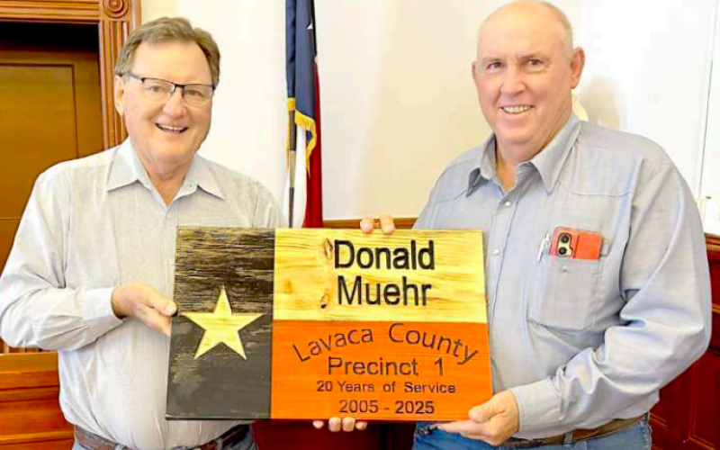 Lavaca County Pct. 1 road and maintenance employee Donald Muehr was presented a retirement plaque at the Monday morning Commissioners’ Court meeting. Muehr is retiring after 20 years of service to the county. Presenting the plaque is Pct. 1 commissioner Edward Pustka (left). Photo by Jimmy Appelt