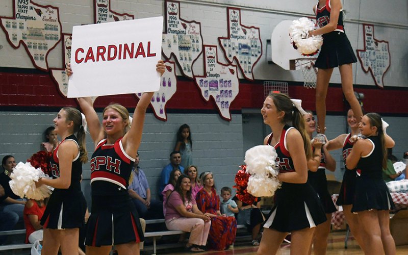 The St. Paul cheerleaders get the Cardinal fans ready for the season at ‘Meet The Cardinals Aug. 5. Photo by Mark Lube.