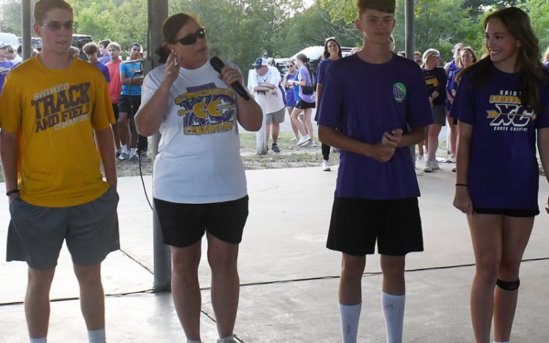 Shiner head cross-country coach Michelle Winkenwerder (center) makes some remarks about the cross-country team Monday evening at ‘Meet The Comanches’. Photo by Mark Lube.