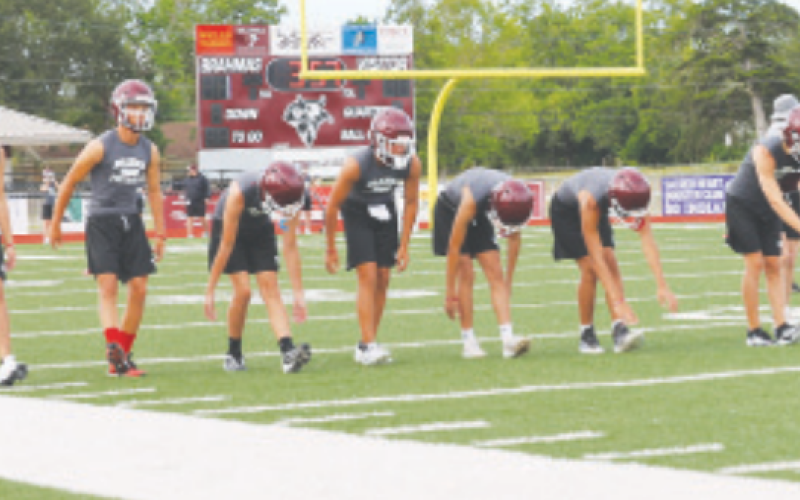 Photo by Chuck Grafe The Brahmas stretch before the Monday evening workout.