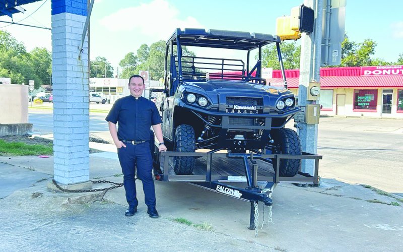 Father Jacob Mendoza is shown with the first place raffle prize, a 2026 Kawasaki Mule Pro FXT 1000LE, which will be given away at the Shiner Catholic Church Fall Picnic slated for Sunday, August 31. This mule includes a Falcon 14 ft. single axle trailer, generously donated by Boehm Tractor Sales. If you would like to purchase a ticket, please call the church office or visit the church’s website, www.sscmshiner.org. Photo by Clayton Kelley.