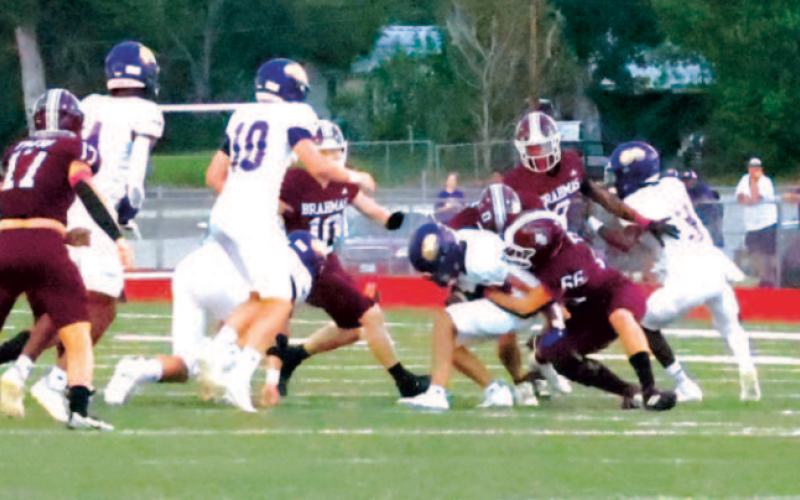 Photo by Chuck Grafe Nathan Henke (66) and Jacob Spangenberg (0) make a tackle in the first period.