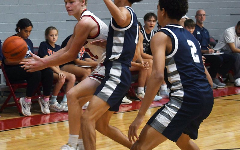 Tyler Pendley tries to pass the ball while dealing with a Goliad double-team. Photo by Mark Lube.