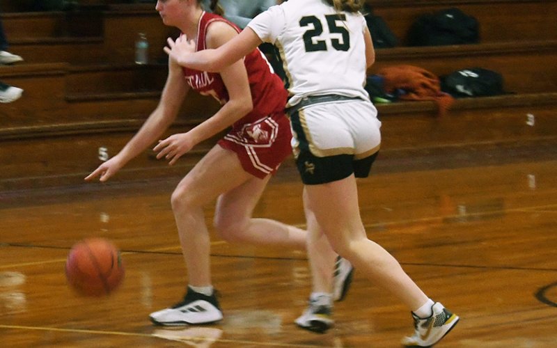 McKinley Jacobs attempts to dribble towards the basket while a Giddings player attempts to slow down or stop her in Thursday’s Flatonia Tournament game won by Giddings 52-49. Photo by Mark Lube.