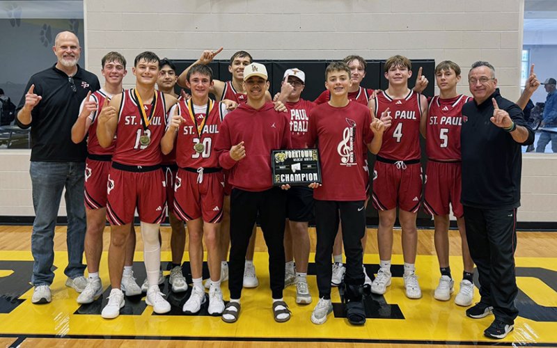 The St. Paul boys basketball team pose with their Yorktown Tournament Champions trophy. Photo courtesy of St. Paul Booster Club.