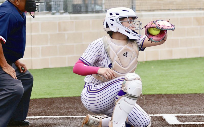Catcher Kenzie Springfield catches a ball during a game at the San Marcos Tournament. Photo courtesy of Louann Heinhsohn.
