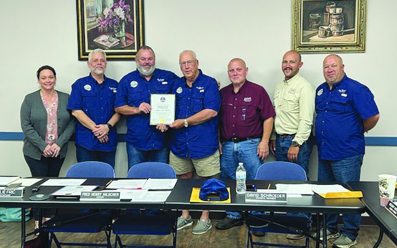 Councilman Gus Jaehne is stepping down from his position as a councilmember, after 16 years of combined service for the City of Shiner. Pictured are, left to right, Natalie Fric, Brady Brown, Jaehne, Mayor Fred Hilscher, David Schroeder, Joey Gamez and Greg Murrile. Photo by Clayton Kelley.