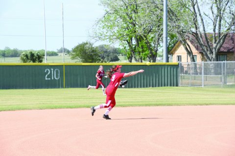 Second baseman Stefany Pokluda makes a throw to first base. Photo by Mark Lube.