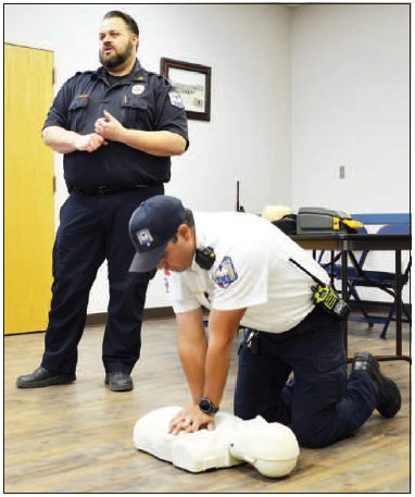 Capt. Jake Tollette explains proper CPR techniques while Asst. Chief Tim Decker demonstrates the procedure during the community CPR class Wednesday, March 30. Photo by Hans Lammeman