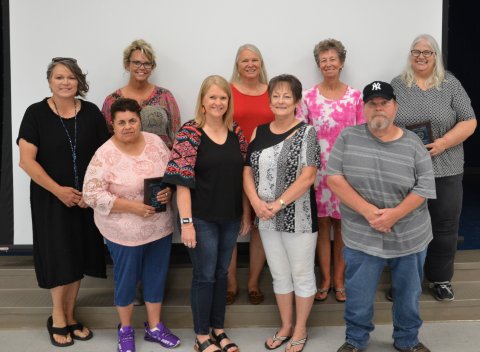 Nine of the 12 2022 YISD retirees pose together on Friday, May 27.