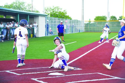 Alaya Boedeker slides into home plate in the second inning. She finished with one run. Photo by Mark Lube.