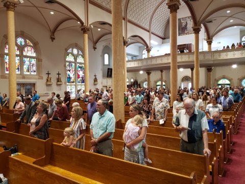 Parishioners lift their voices in song for the day’s centennial celebration in Shiner. Aside from the vast arches of that ceiling and remarkable colors throughout, I particularly like having captured that painting, way back there above the choir loft. With so much else to fill your eye in this place I’m betting that has to be one of the most underappreciated works in the whole building.