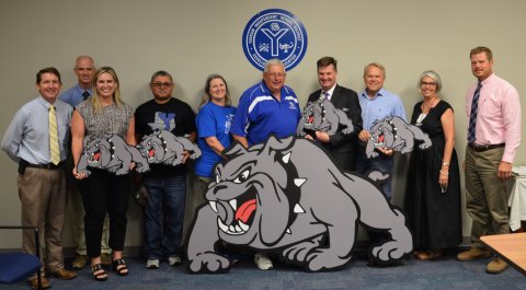 Yoakum Primary Annex Principal Patrick Brewer, Yoakum Junior High School Principal Jay Quinney, Yoakum High School Principal Maci McDonald, Robert Hernandez, Amy Jirkovsky, Larry Jirkovsky, YISD Superintendent Tom Kelley, YISD School Board President Glen Kusak, Yoakum Primary School Principal Rebecca Fitch and Yoakum Intermediate School Principal Gabe Adamek pose with donated signs during Aug 8 YISD School Board meeting. 