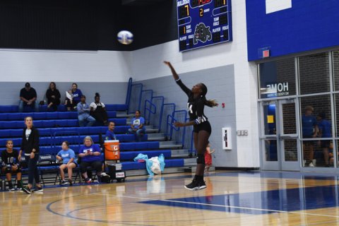 Jayana Phillips serves against Shiner. Photo by Mark Lube.