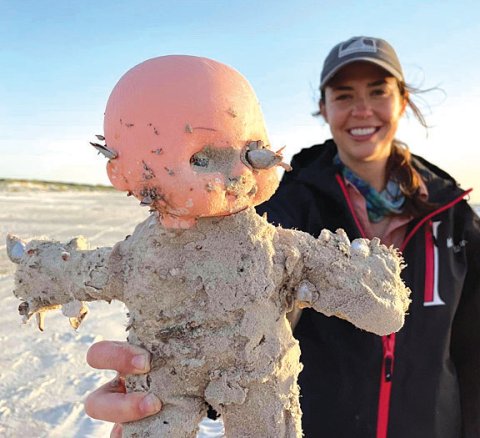 A Mission-Aransas Reserve employee holds one of the dolls covered in barnacles with a disfigured eye socket. Photo courtesy Mission-Aransas Reserve