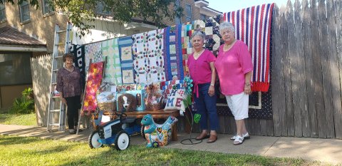 Pictured with just a few of the great items that will appear in Sunday’s action are, from left, Rose Selzer, Joyce Pavlicek and Gussie Machalec.
