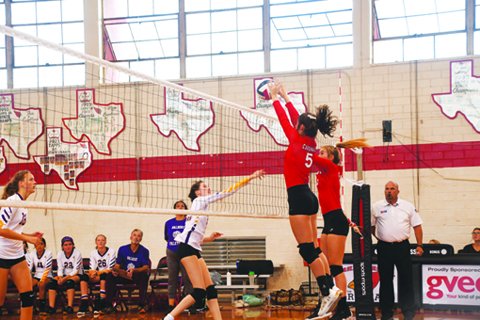 Ashlyn Pesek and Dallyn Pesek get their hands on a Waldorf hit on Thursday. Photo by Mark Lube.