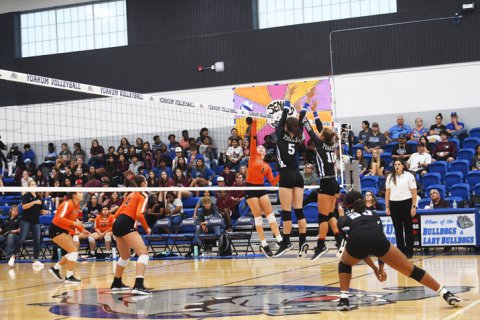 Addison Pekar and Samantha Adamek attempt a block in the Sept. 6 match against Gonzales. Yoakum has won their first two district matches.