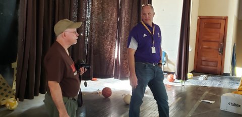 Local historian Doug Kubicek and Shiner superintendent Alex Remschel gave us a tour of the Old Shiner Gym last week. Seen here on the old stage, the two are discussing what all still might need doing to make this a 100% usable facility as it was intended—replacing just one set of curtains for use on the stage runs in the tens of thousands of dollars, all the way around would run in the hundreds of thousands. Remschels said. Even more would be needed to bring the stage lighting up to snuff.