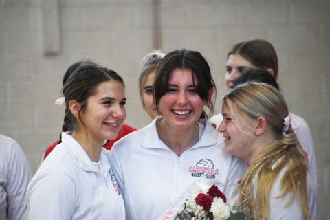Stefany Pokluda (left) and Maurin Knesek embrace senior manager Alexa Escobar. Photo by Mark Lube.