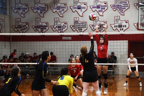Ashlyn Pesek tries a block. Photo by Mark Lube.