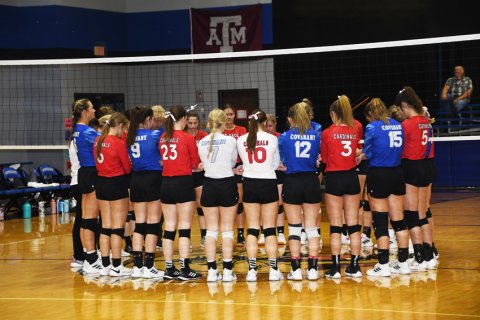 The Lady Cardinals and Lady Cougars gather together to pray before the match. Photo by Mark Lube,