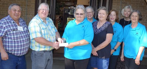Pictured are, left to right, Assistant Museum Curator Roy Rivera, Museum Curator Duff Wagner, Guild President Janet Ferguson, Guild members Mary Shafer, Beverly Svetlik, Carolyn Hilscher, Toni Rogers and Irene Cerny.