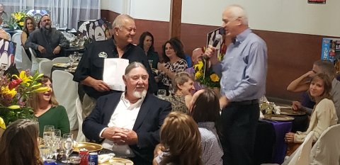 Robert Werner makes his way through the crowd, just before dinner is served Saturday, to rub elbows with some of the day's largest donors toward the Old Shiner Gym projects. Seated in the foreground is Mark Hagens, owner of H&C Construction. The tall fellow standing there is Douglas Kaspar, son of Dan Kaspar and now the namesake to his charitable foundation.