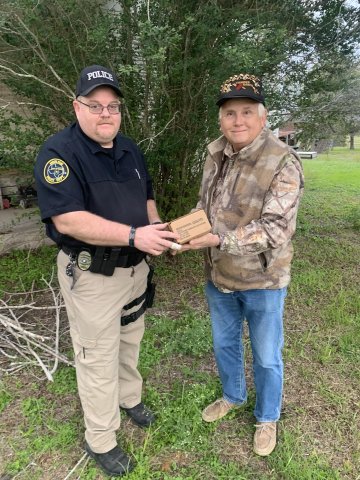 Moulton Police Officer Jeff Alexander accepts the donated service ammunition from local resident Jimmy Bryan, who has offered up his private shooting range to Moulton police for years now whenever they need to update their annual qualifications. Photo by Daniel Beyer