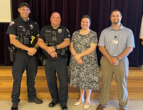 Pictured are, left to right, Officer Proske, Sgt. Kevin Kelley, Sarah Fisher and Dr. Kody Selzer.