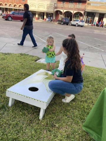 A child plays corn hole at the Turtle Wing Foundation’s Monster Dash event in October.