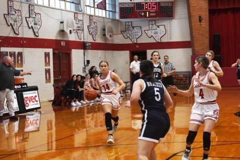 Avery Pesek dribbles against Bracken.  Photo by Mark Lube.
