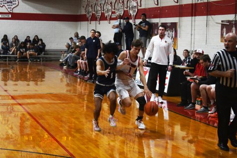 Trent Brown is  defended by a Bracken player in the second half. Photo by Mark Lube.