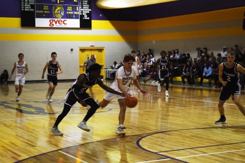 Keyshaun Green of Flatonia (left) attempts to knock the ball out of the hands of Drew Wenske as Wenske dribbles toward the basket last Friday in Shiner’s home game against Flatonia. Photo by Mark Lube.