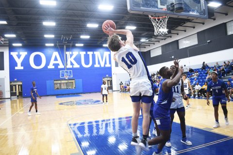 Austin Novosad makes a jump shot in the paint. Photo by Mark Lube.