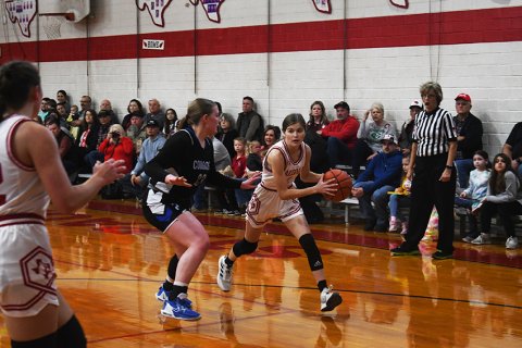 One of the St. Paul seniors, Anna Reeves, looks for an open teammate to pass to.. Photo by Mark Lube.