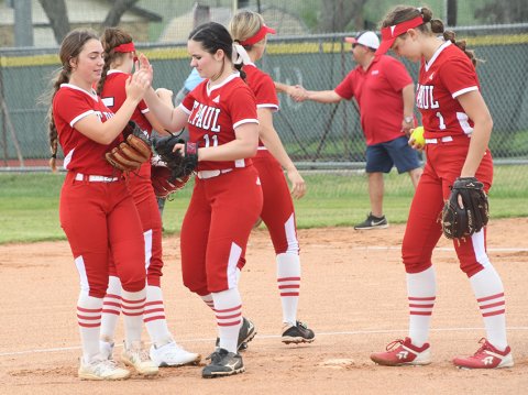 St. Paul’s infield huddles before resuming play against the Lady Patriot batters. Photo by Mark Lube. 