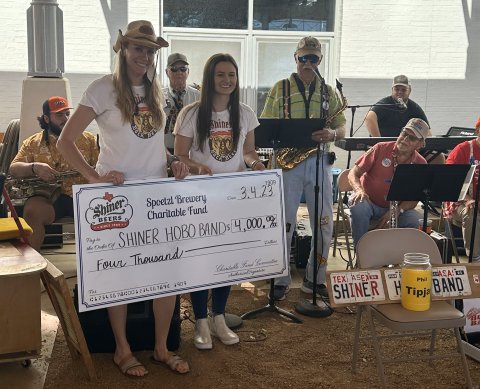 Pictured are Julie Boehm (Spoetzl Brewery Charitable Fund member) and Lauren Schuette (Spoetzl Brewery Charitable Fund member) with members of the Shiner Hobo Band.