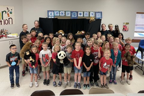 First and second grade students from St. Ludmila Elementary with members of the Shiner Pilot Club.