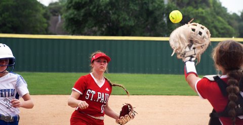 Catcher Tori Walker (right) handles a pass from third baseman Hailey Radicke during the second and final game of St. Paul’s regular-season, district series with the Sacred Heart Indianettes on Thursday. St. Paul played a non-districrt game at Burton on Tuesday.  Photo by Mark Lube.