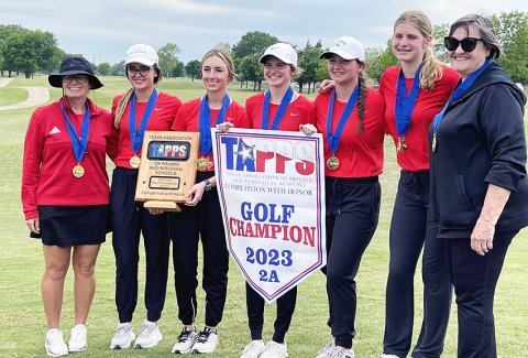 The Lady Cardinals pose with their trophy and banner from 2A state golf championship. From left is head coach Nicco Brown, Audrey Thibodeaux, Cortney Tuch, Anna Reeves, Emily Stamport, Riley Mozisek and assistant coach Pat Chilek.Photo courtesy of Nicco Brown.