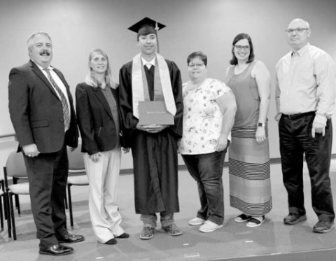 Blake Reed posing for graduation with his family