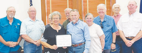 DeWitt County commissioners present a recognition to members of the DeWitt County Historical Commission for the group’s active and well-balanced preservation program at Monday’s county business meeting.